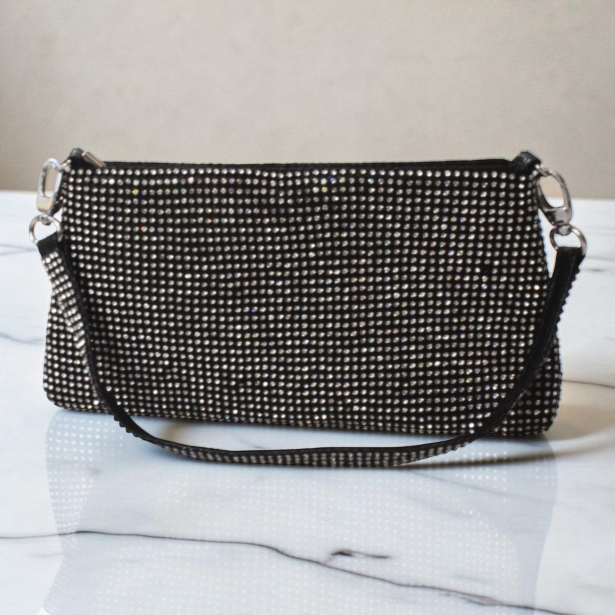 Sleek black glitter shoulder purse with subtle shimmer and a classic party-ready silhouette.
