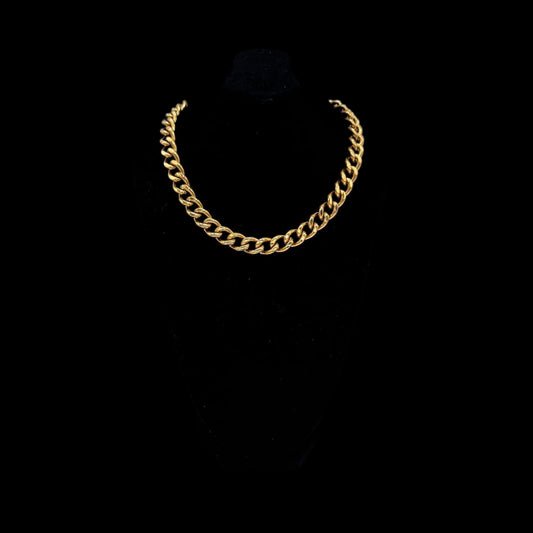 Gold chain necklace on a black background