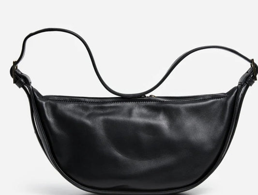 Dorole Ambra Crossbody Bag in black showcasing its sleek silhouette and adjustable shoulder strap.