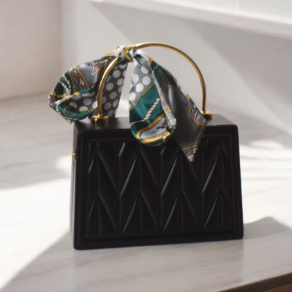 Dorole Bow Evening Bag in black with a stylish scarf detail, perfect for adding glamour to evening outfits.