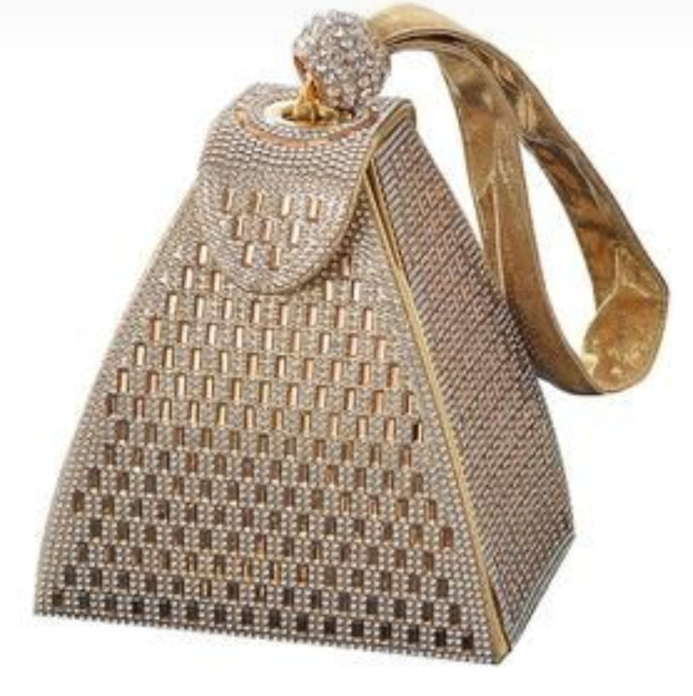 Gold and diamond-encrusted handbag on a white background