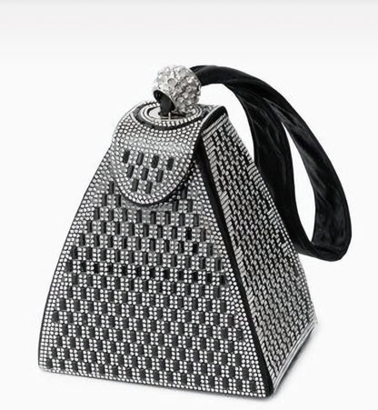Decorative cowbell with rhinestone embellishments on a white background