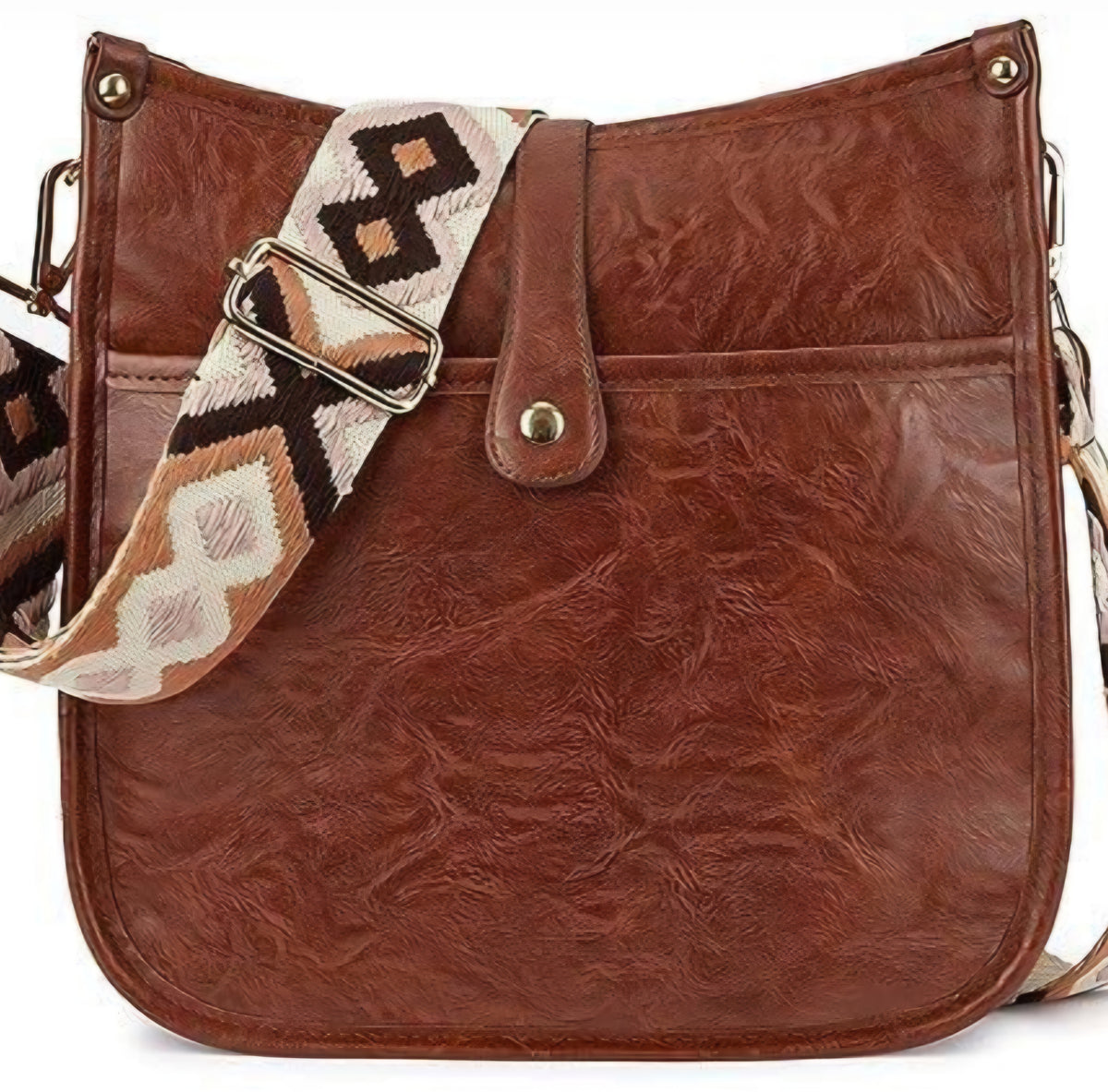 A brown crossbody bag with a brown textured surface, a front flap with a metallic buckle, and an extendable white and brown patterned strap.