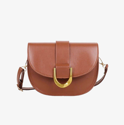 Brown leather handbag with gold buckle on a white background