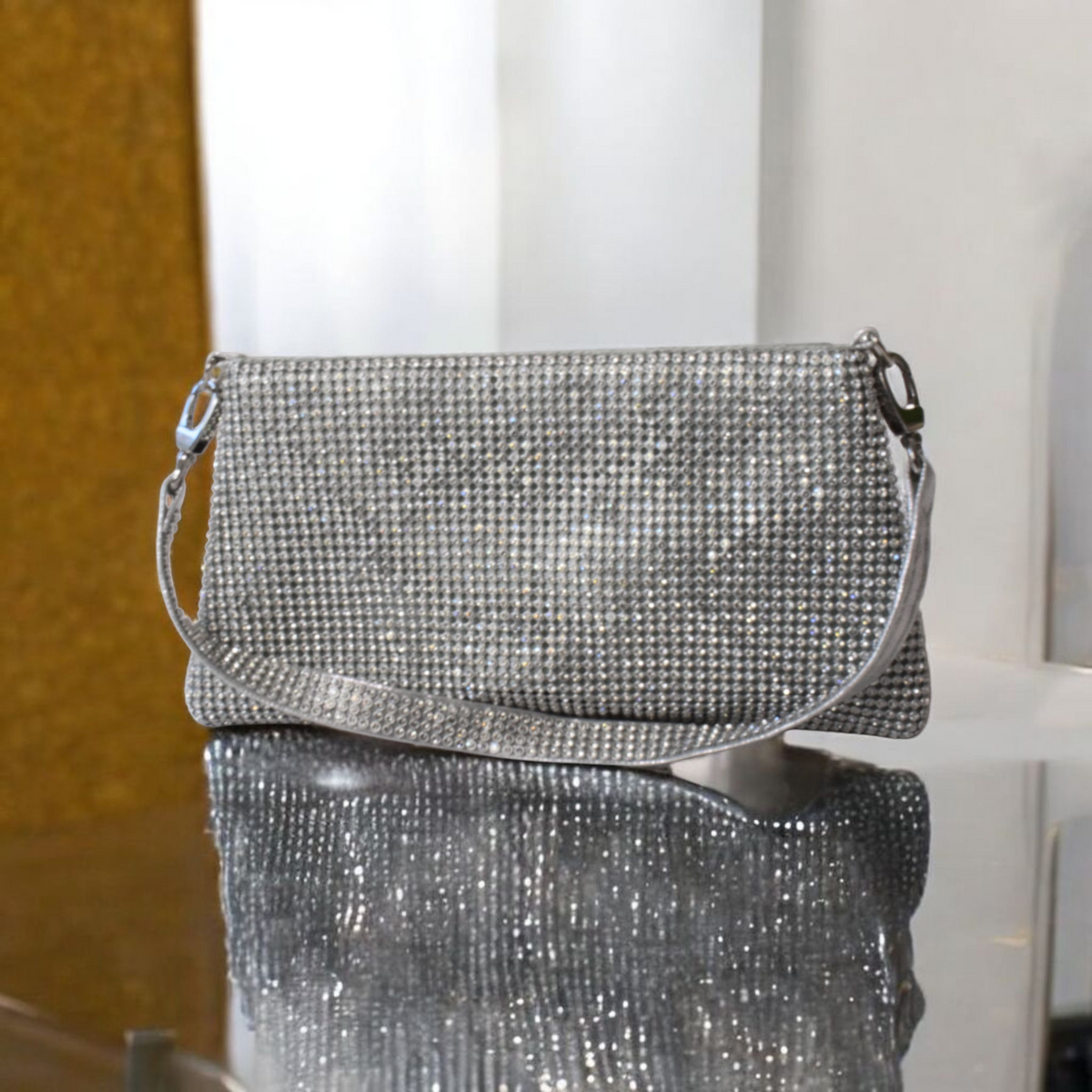 Shimmering silver glitter clutch handbag with a compact structured design and shoulder strap.
