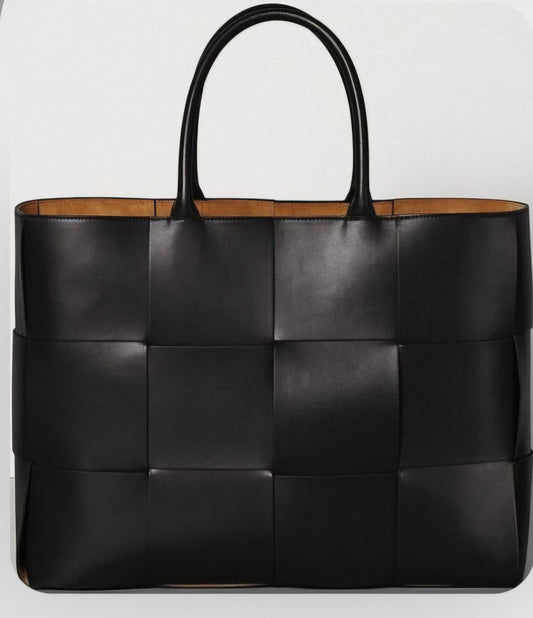 A black leather tote bag with a woven design and two handles.