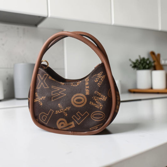 Brown handbag with decorative patterns on a kitchen counter