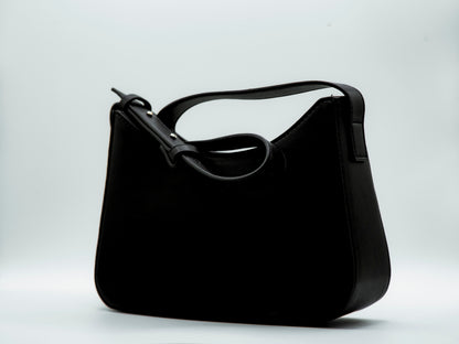 Black handbag on a light gray background
