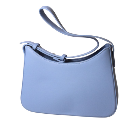 A blue shoulder bag with a smooth solid texture, featuring a strap and a minimalist design.