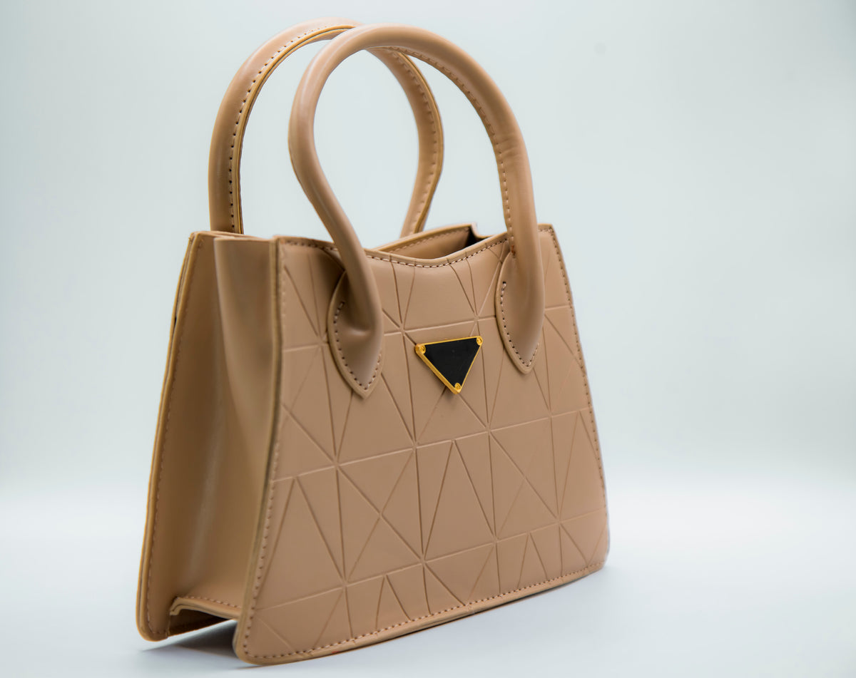 Beige handbag with a geometric design on a light gray background