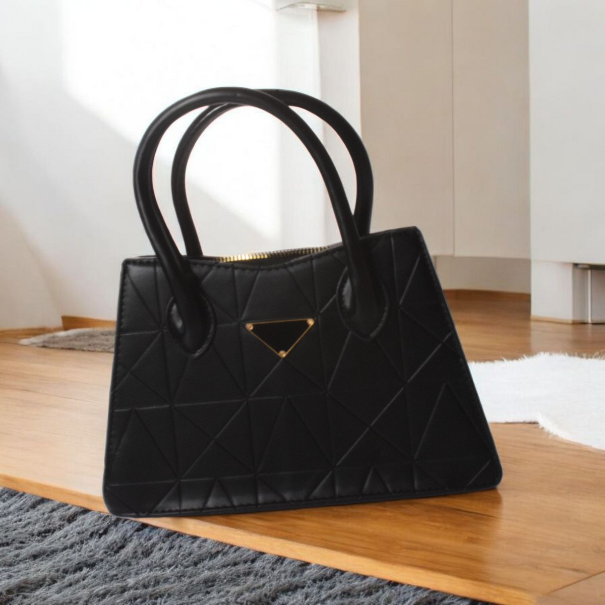 Black quilted handbag on a wooden floor with a neutral background