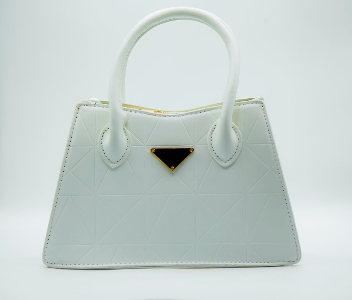 White handbag with a gold accent on a white background