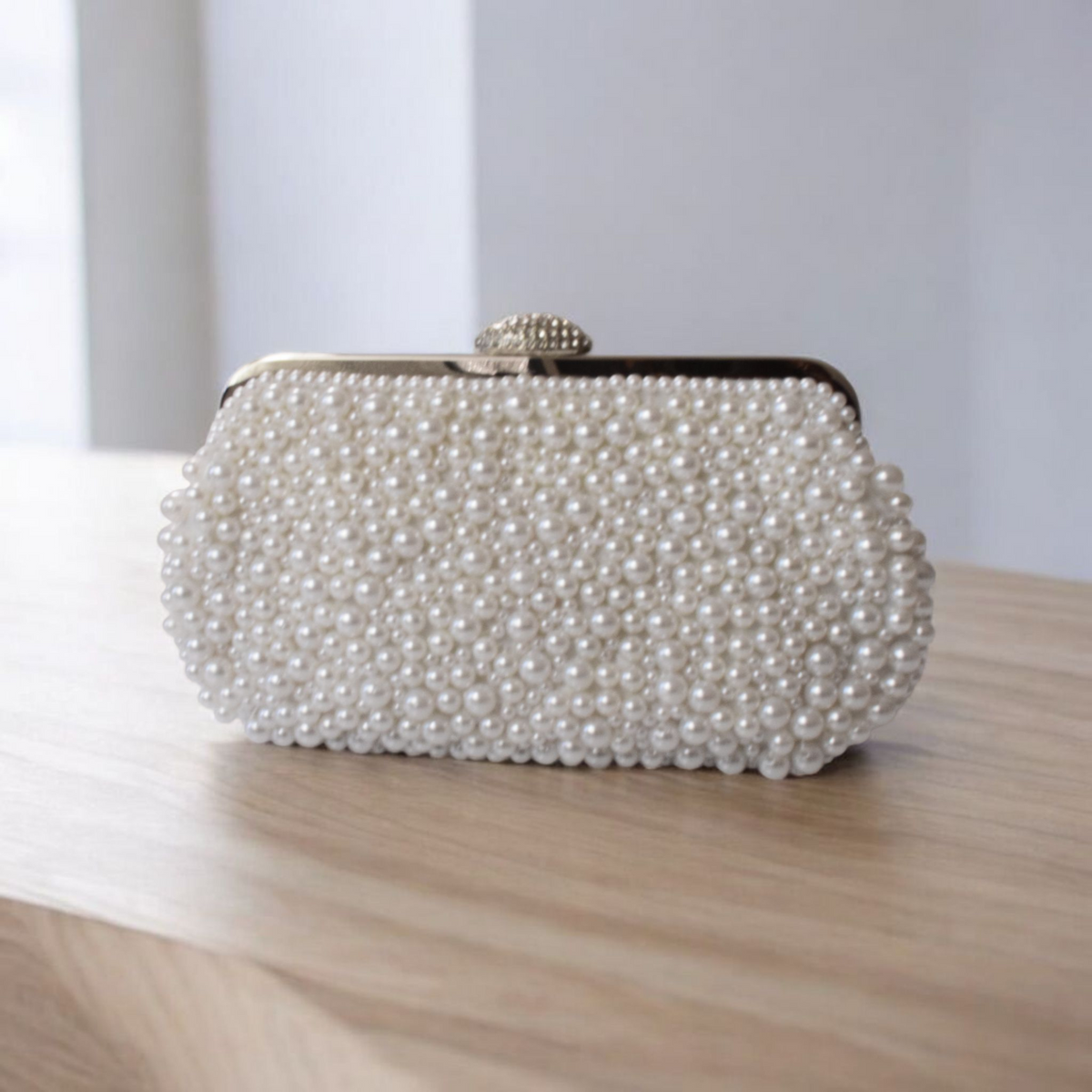 Classic off-white bridal evening purse with intricate pearl floral detailing and metallic clasp closure.