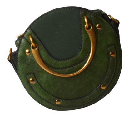 Green handbag with gold handles on a white background