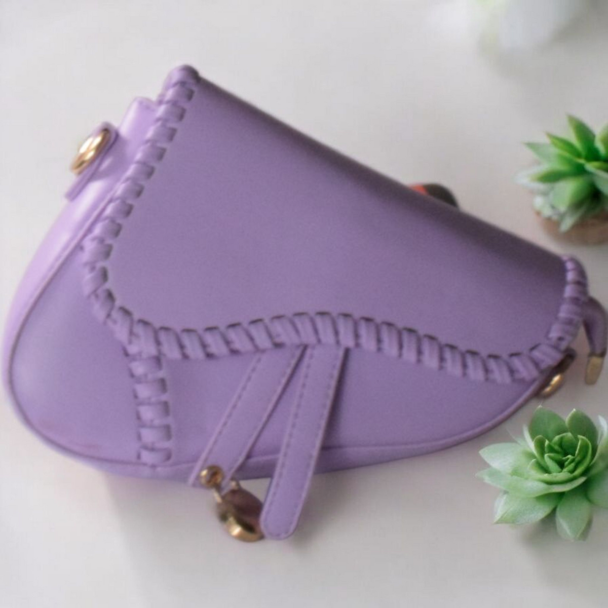 Dorole Spirt Shoulder Bag in soft lavender with unique stitching and adjustable strap on a light background.