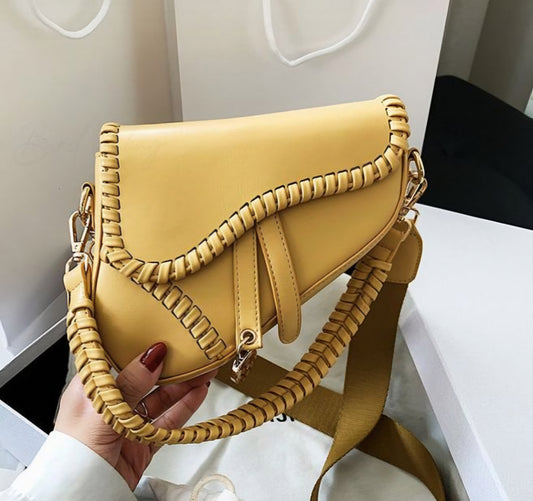 Dorole Spirt Shoulder Bag in yellow, showcasing unique stitched design and adjustable strap for modern style.
