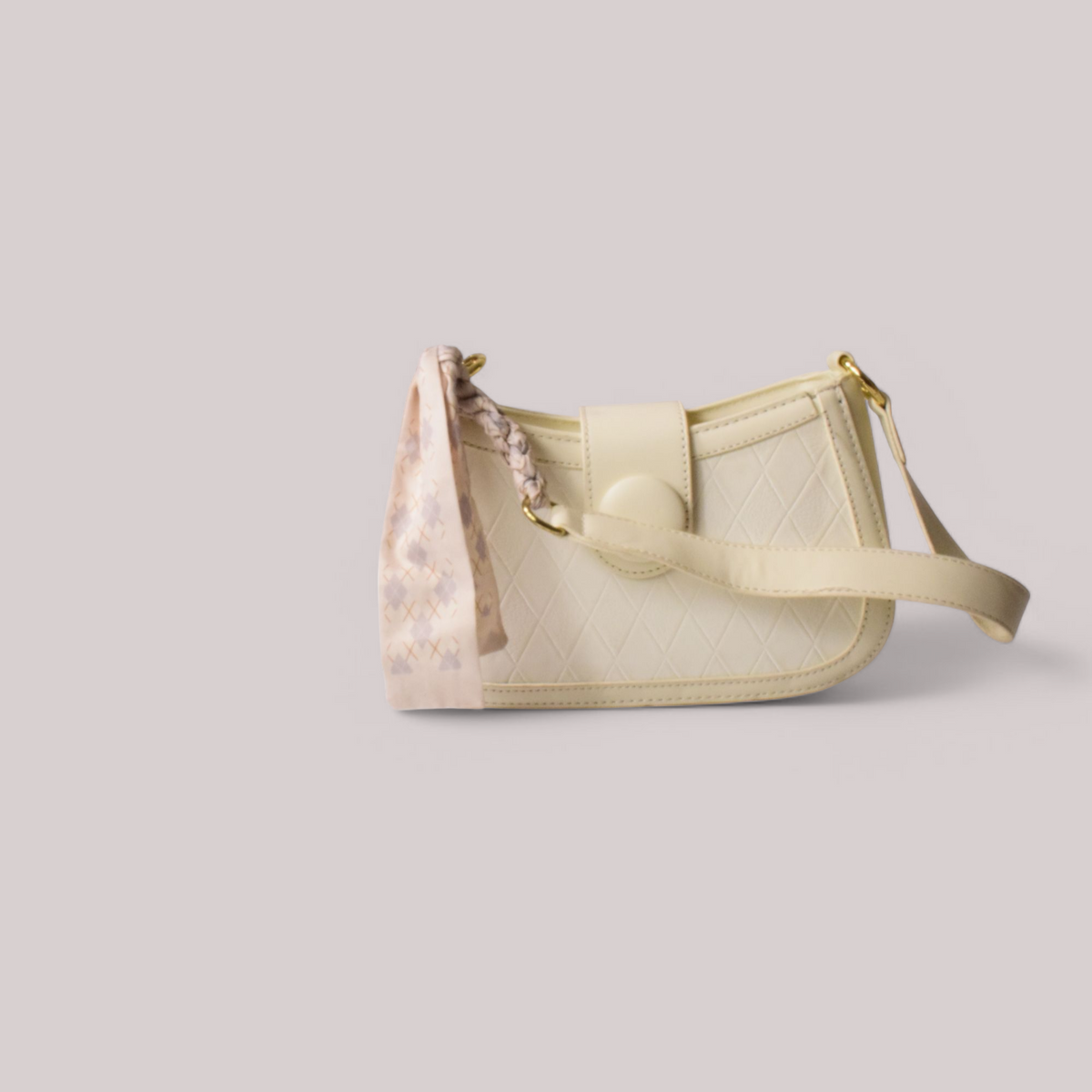 Cream-colored handbag with floral pattern on a light gray background