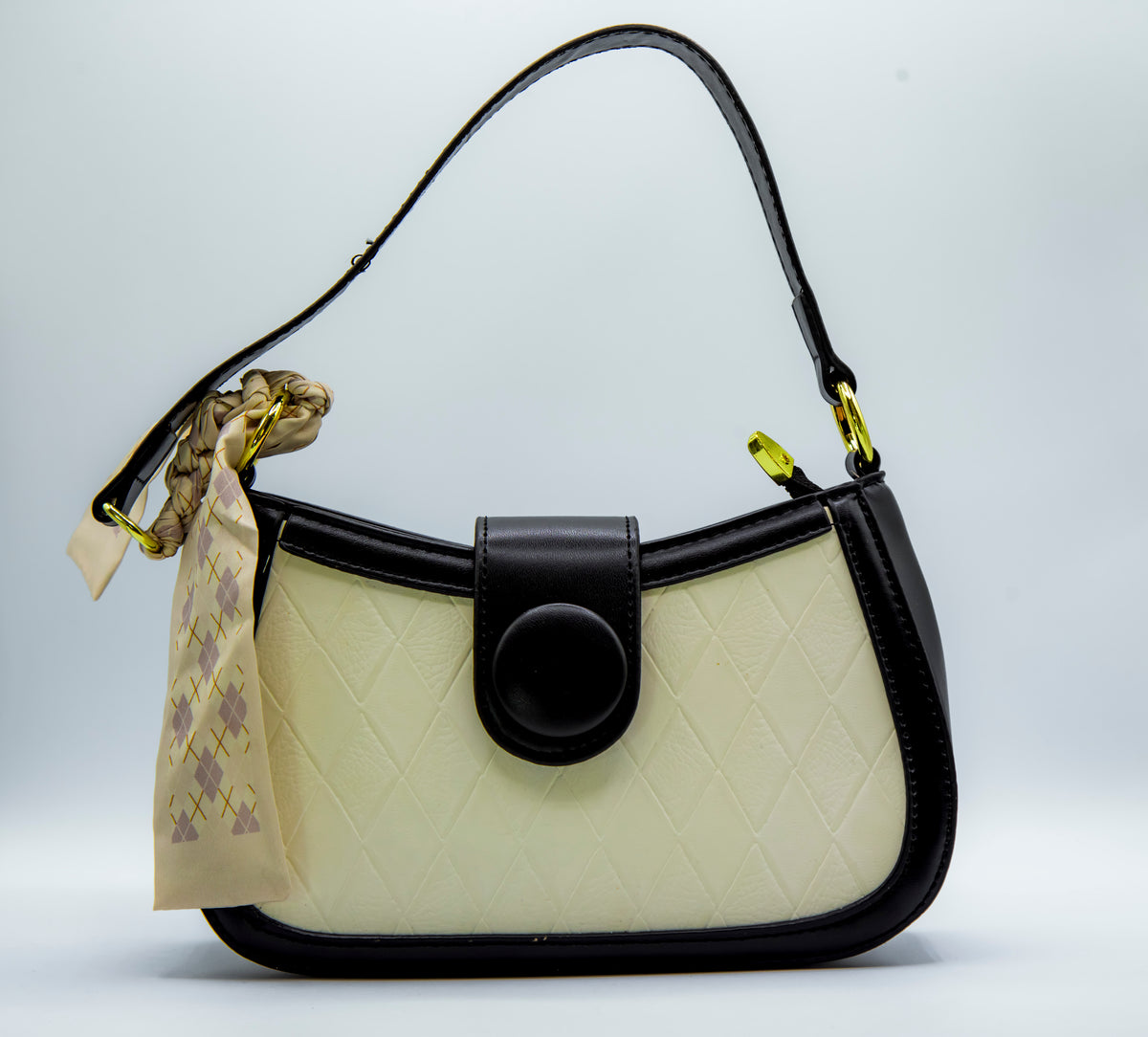 Handbag with a visible brand tag on a light gray background