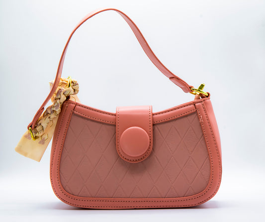 A pink Dorole Verada shoulder bag with a quilted design, a circular clasp, and a detachable strap.