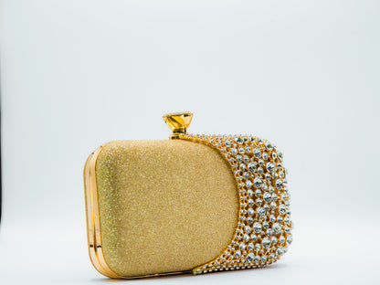 Gold clutch bag with crystal embellishments on a white background