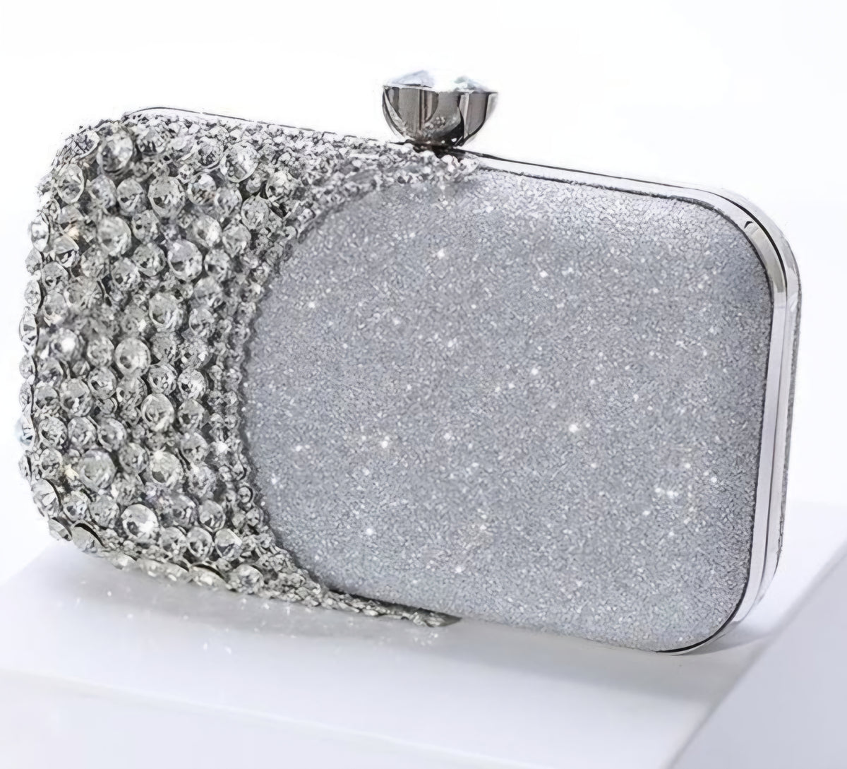 Silver clutch bag with rhinestone embellishments on a white background