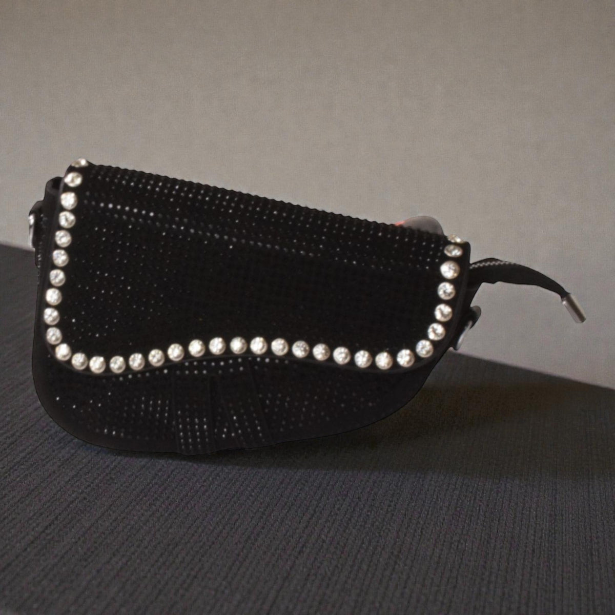 Black rhinestone-embellished shoulder bag featuring a sleek structured shape and chain strap.