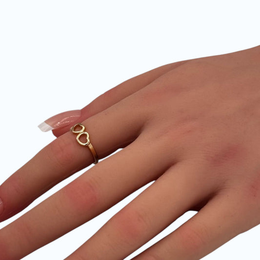 Double Heart Ring gold tone ring with open heart design worn on woman finger
