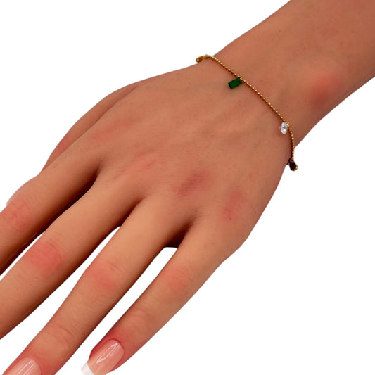 Gemstone Detail Bracelet gold chain with green gem charm on woman wrist