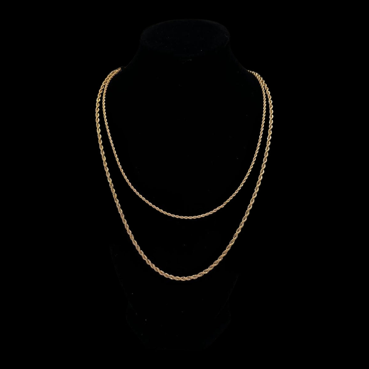 Gold chain necklace on a black background