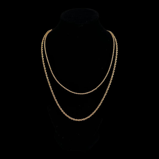 Gold chain necklace on a black background