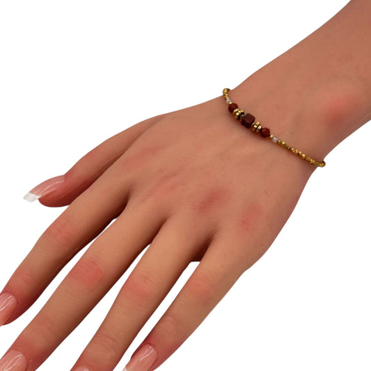 Natural Bead Chain bracelet with dark beads and gold accents worn on woman wrist