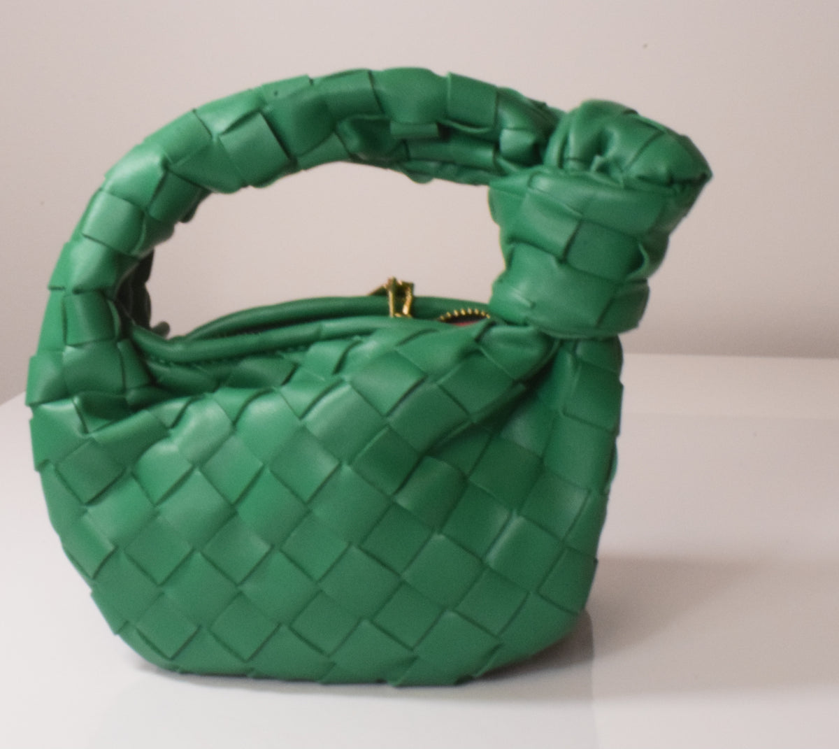 Horn Knotted Underarm Handbag women's woven shoulder bag on plain background