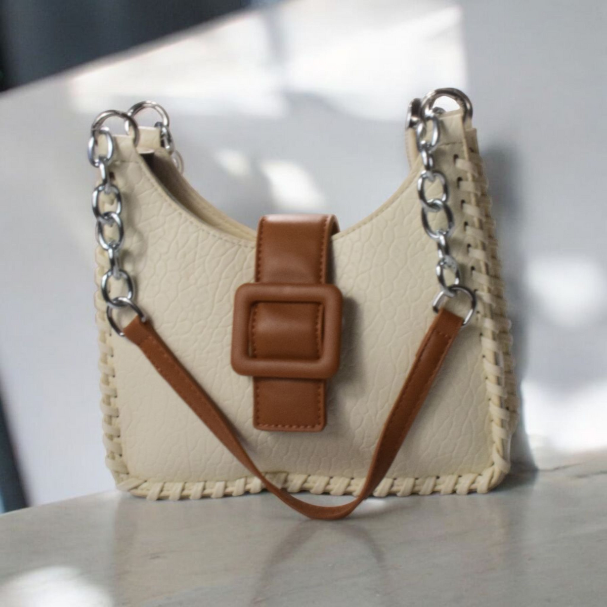 Shockcrush Chic Square Shoulder Bag vegan leather women's handbag on marble surface