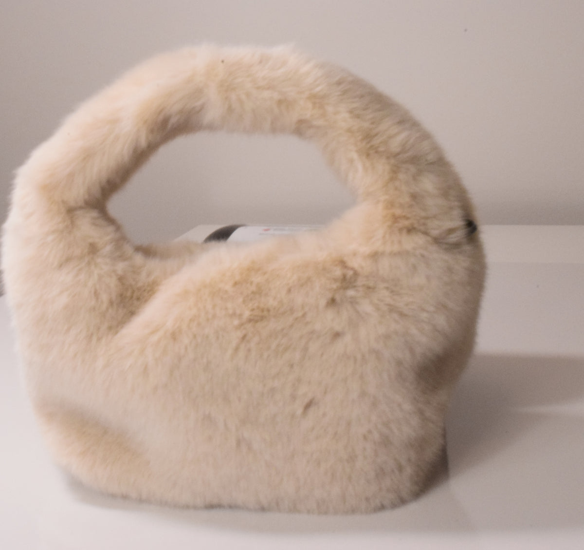 Beige fur-lined ear muffs on a white background