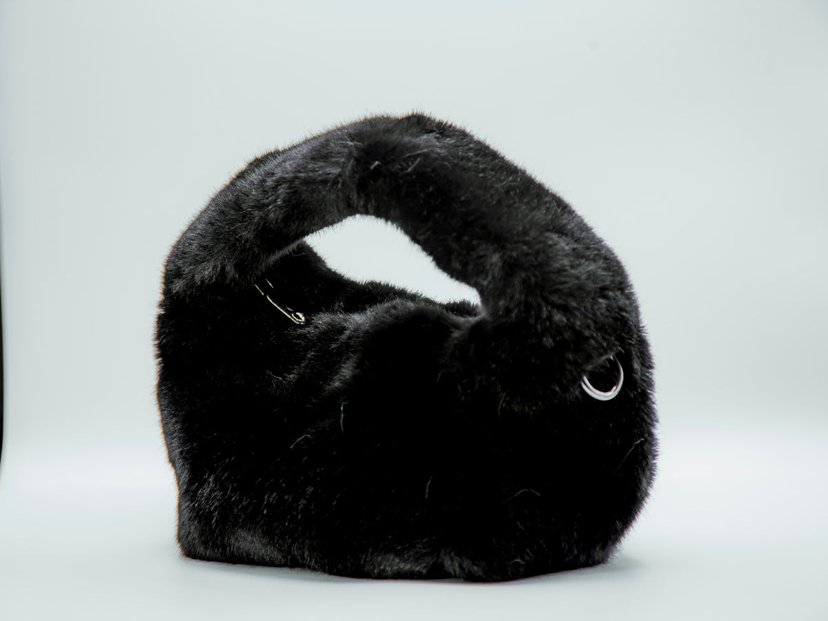 Black fur handbag on a white background