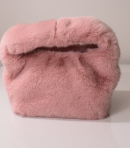 A pink soft volume top-handle bag on a white background.
