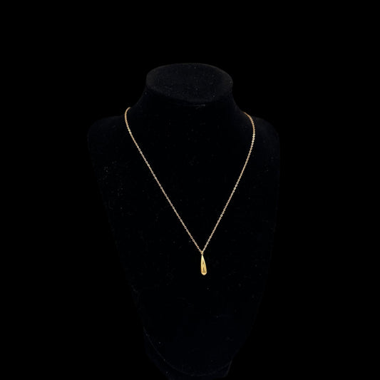 Gold-tone chain necklace featuring a smooth, sculpted teardrop pendant.